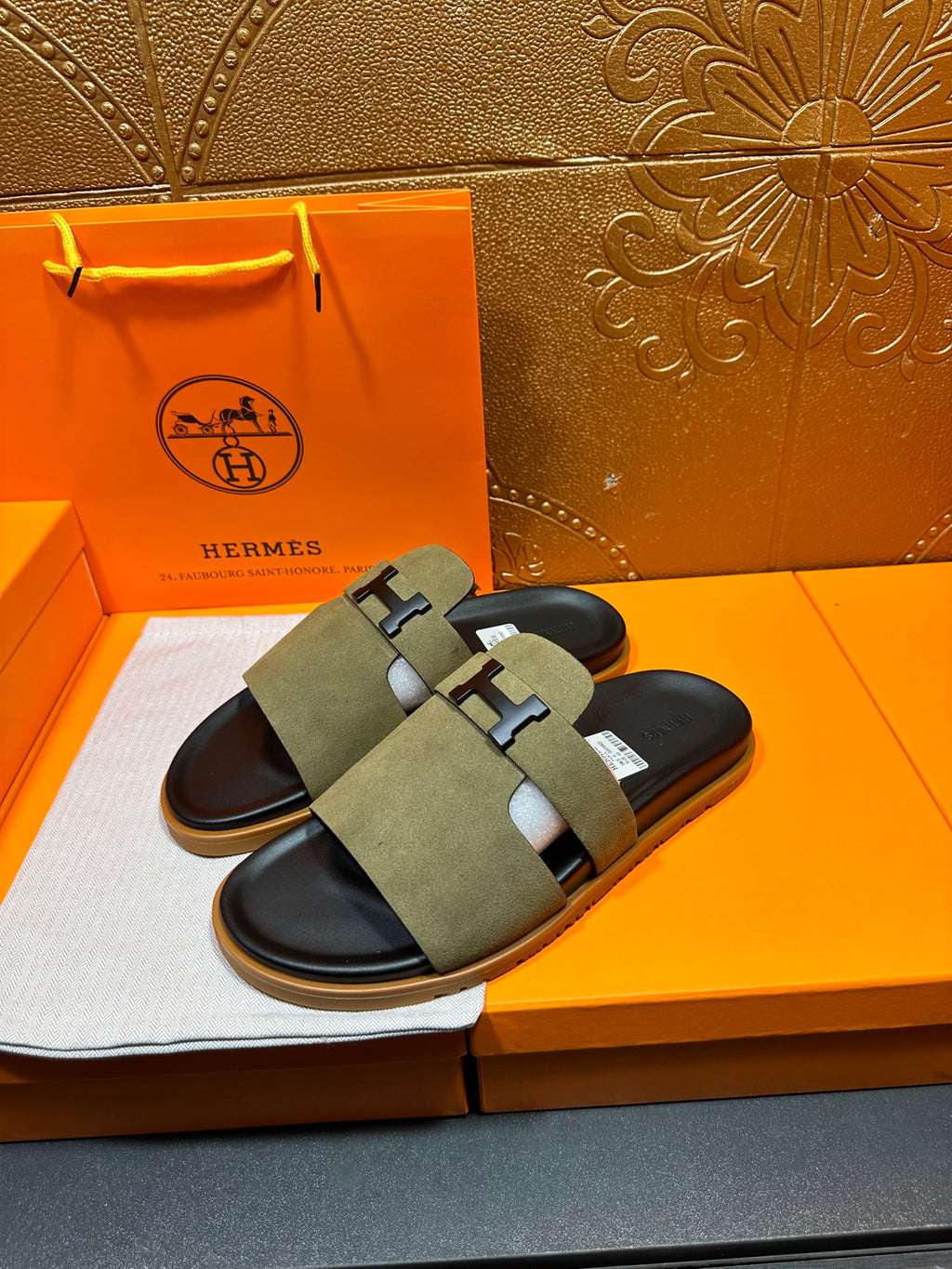 Olive suede slide sandals with black footbed and H buckle crossover strap