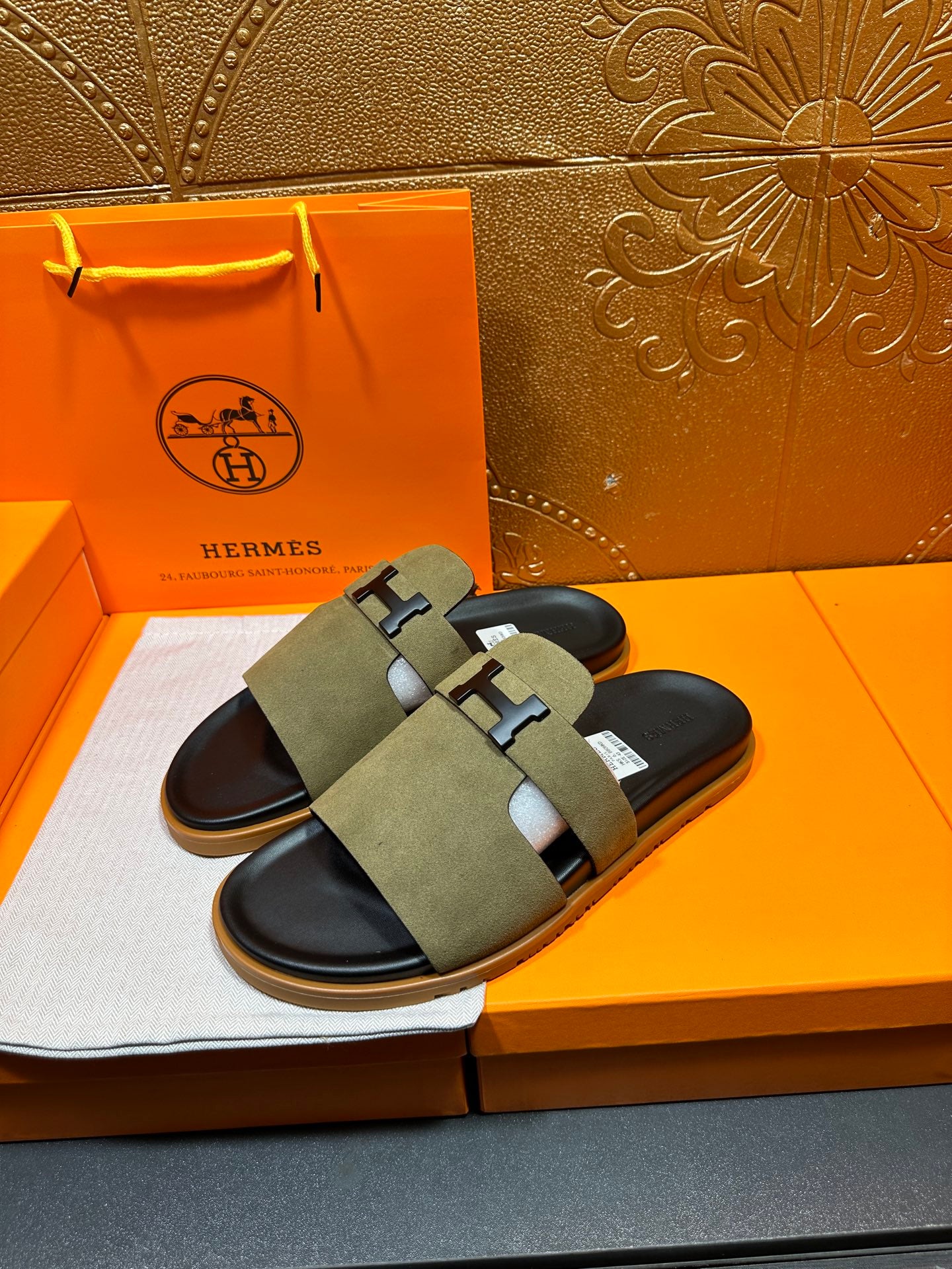 Olive suede slide sandals with black footbed and H buckle crossover strap