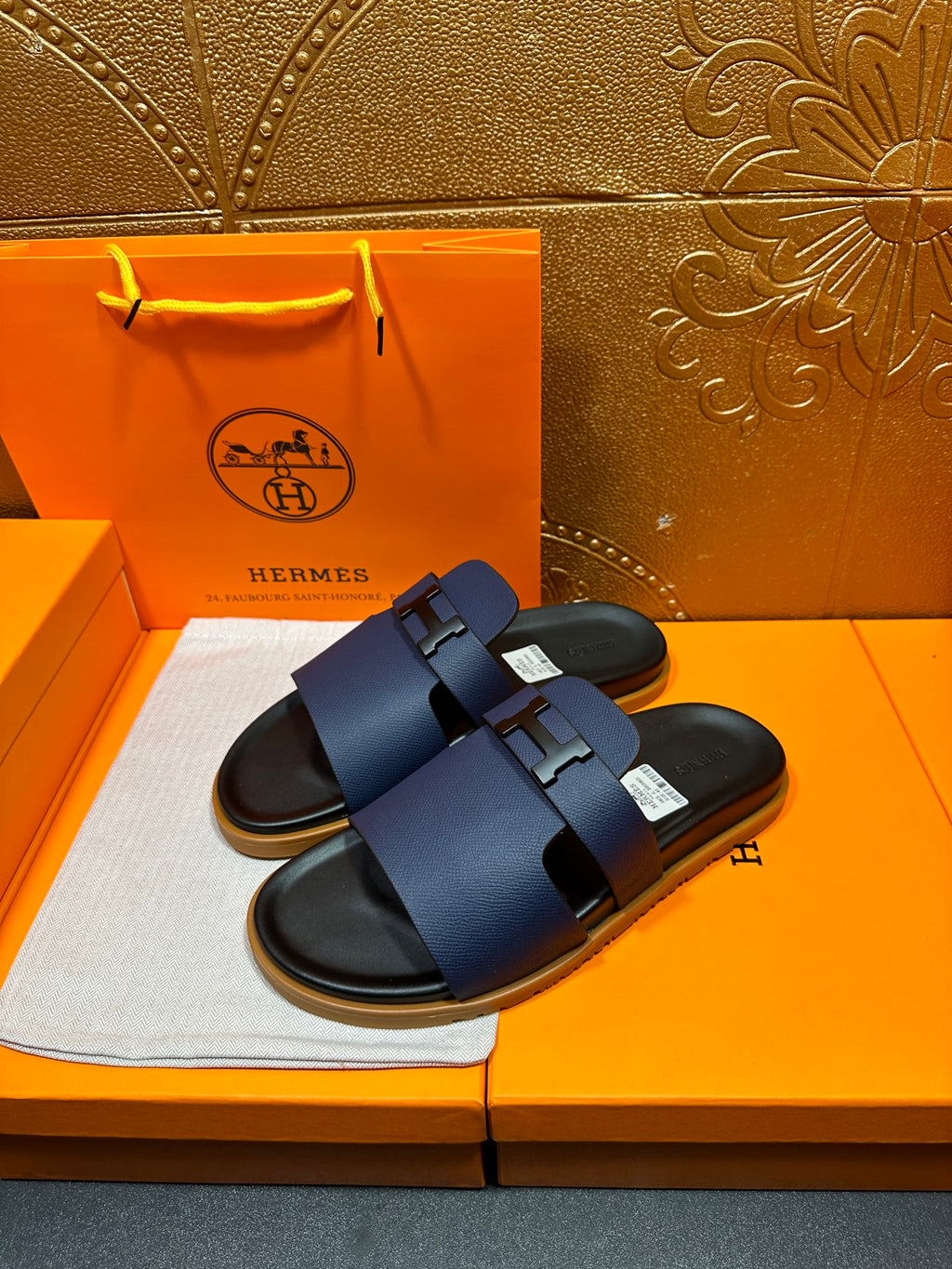 Pair of dark blue leather sandals with buckle straps and black footbed