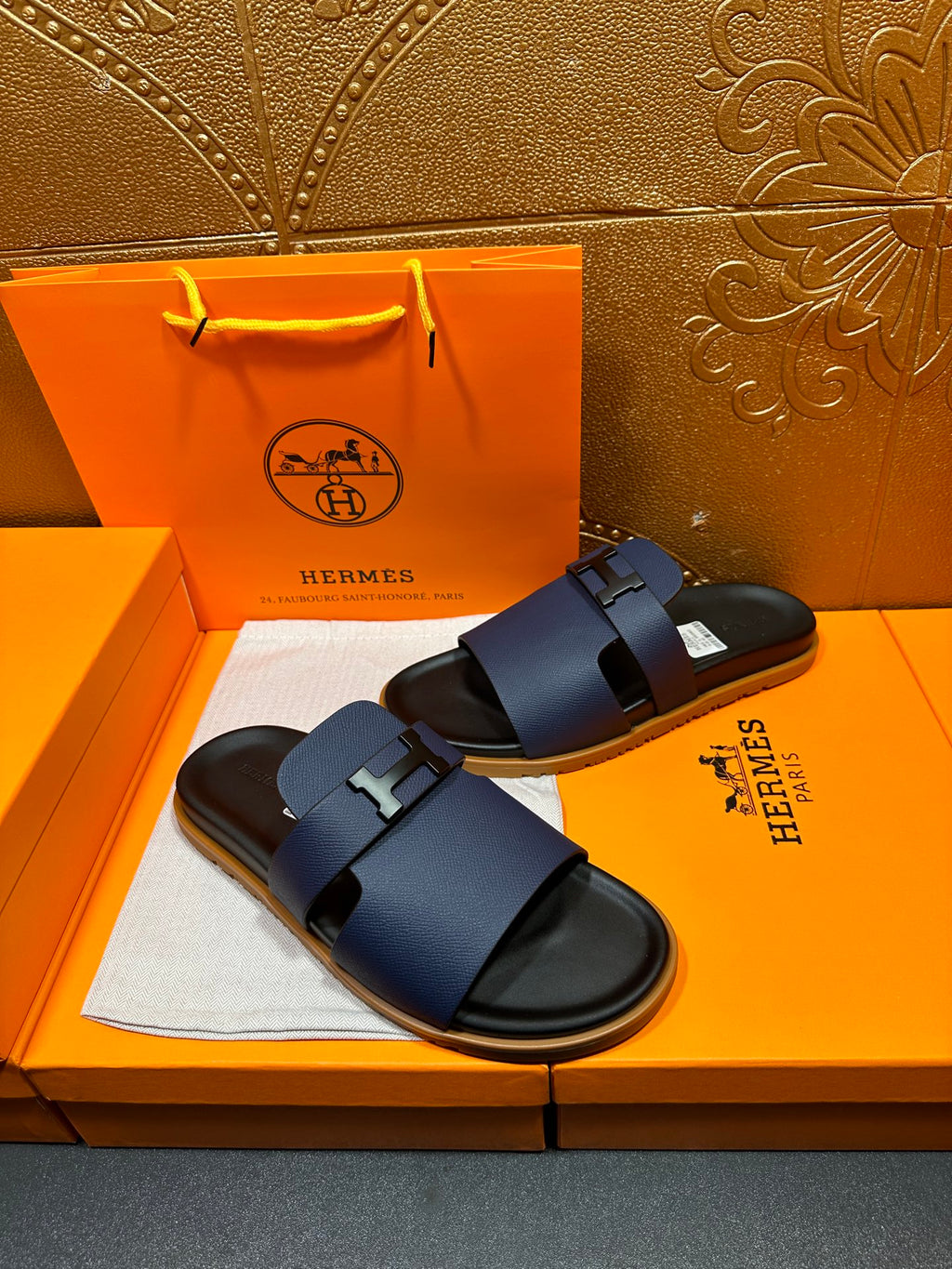 Dark blue leather sandals with double strap and metal buckle, black sole trim