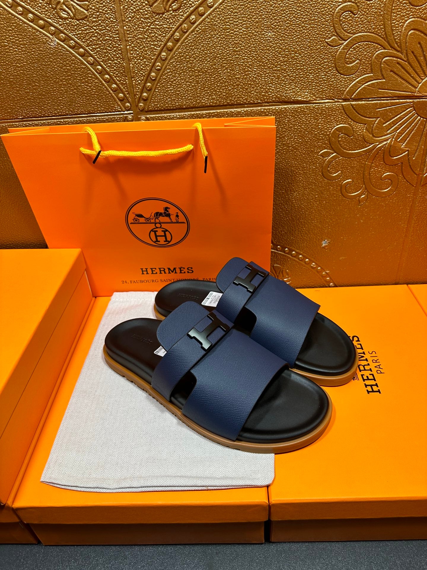 Dark blue leather slide sandals with buckle detail and black contoured sole