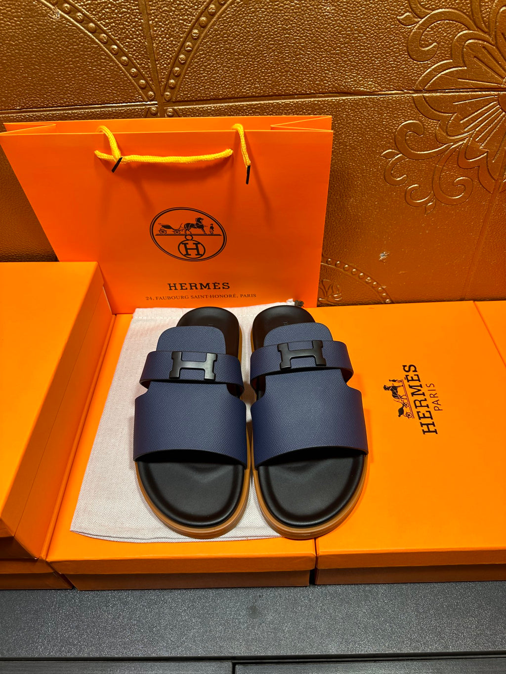 Dark blue leather slide sandals with squared buckle strap and black rubber sole