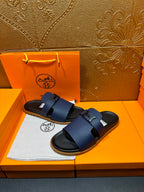 Blue leather slide sandals with adjustable buckle strap and black rubber outsole