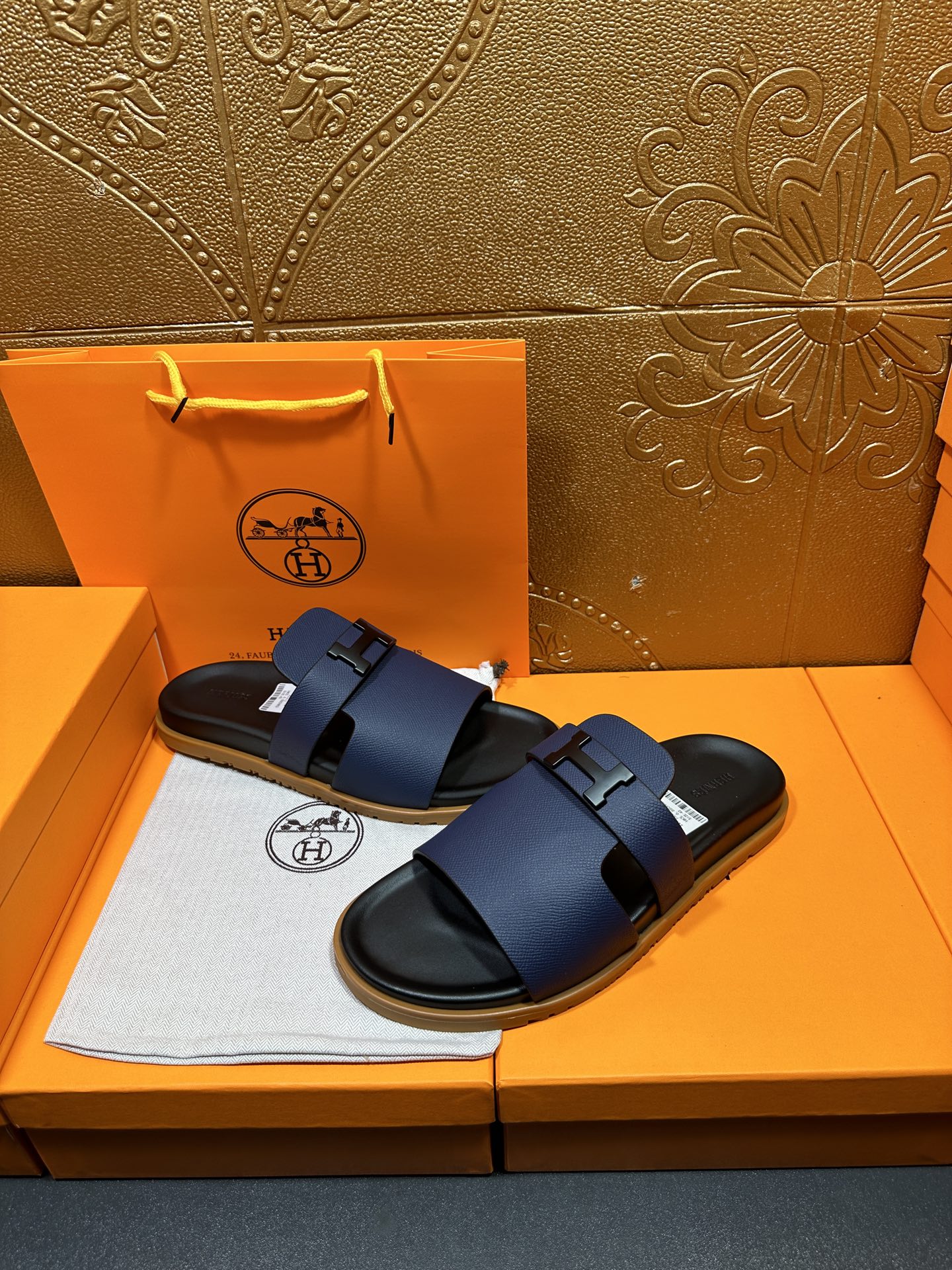Blue leather slide sandals with adjustable buckle strap and black rubber outsole