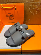 Dark gray slide sandals with H-style buckle, dual straps, flat rubber sole