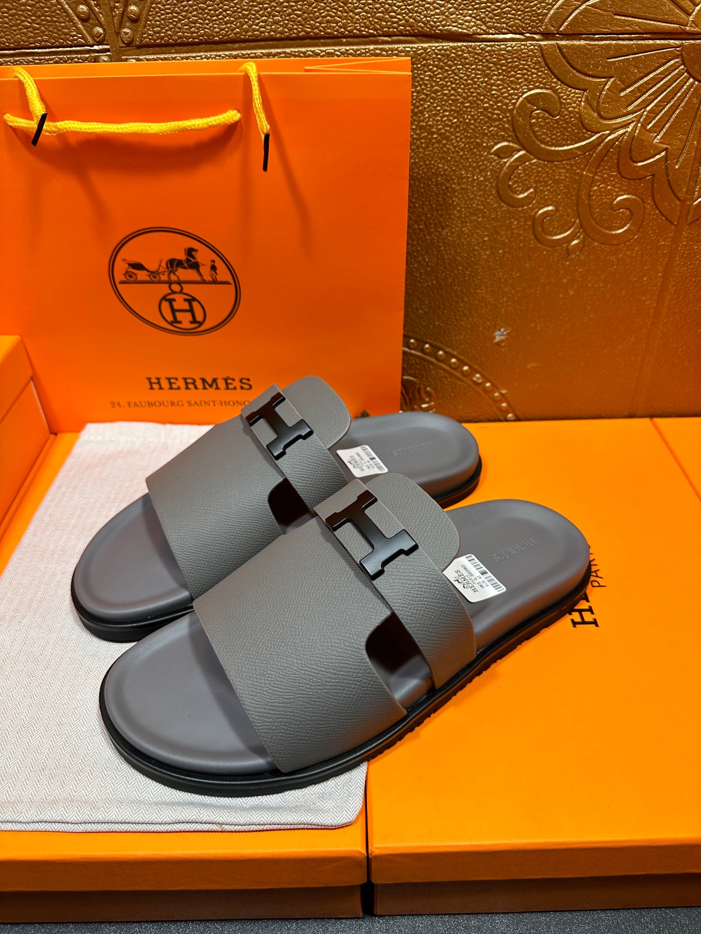 Dark gray slide sandals with H-style buckle, dual straps, flat rubber sole