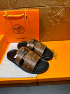 Hermes sandals with brown textured crossover straps and black rubber footbeds