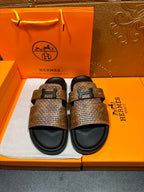 Hermes sandals with brown textured straps, black footbeds, metal H-style buckle