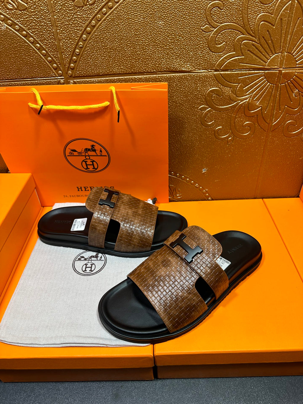 Hermes sandals with brown textured slide straps and black rubber soles
