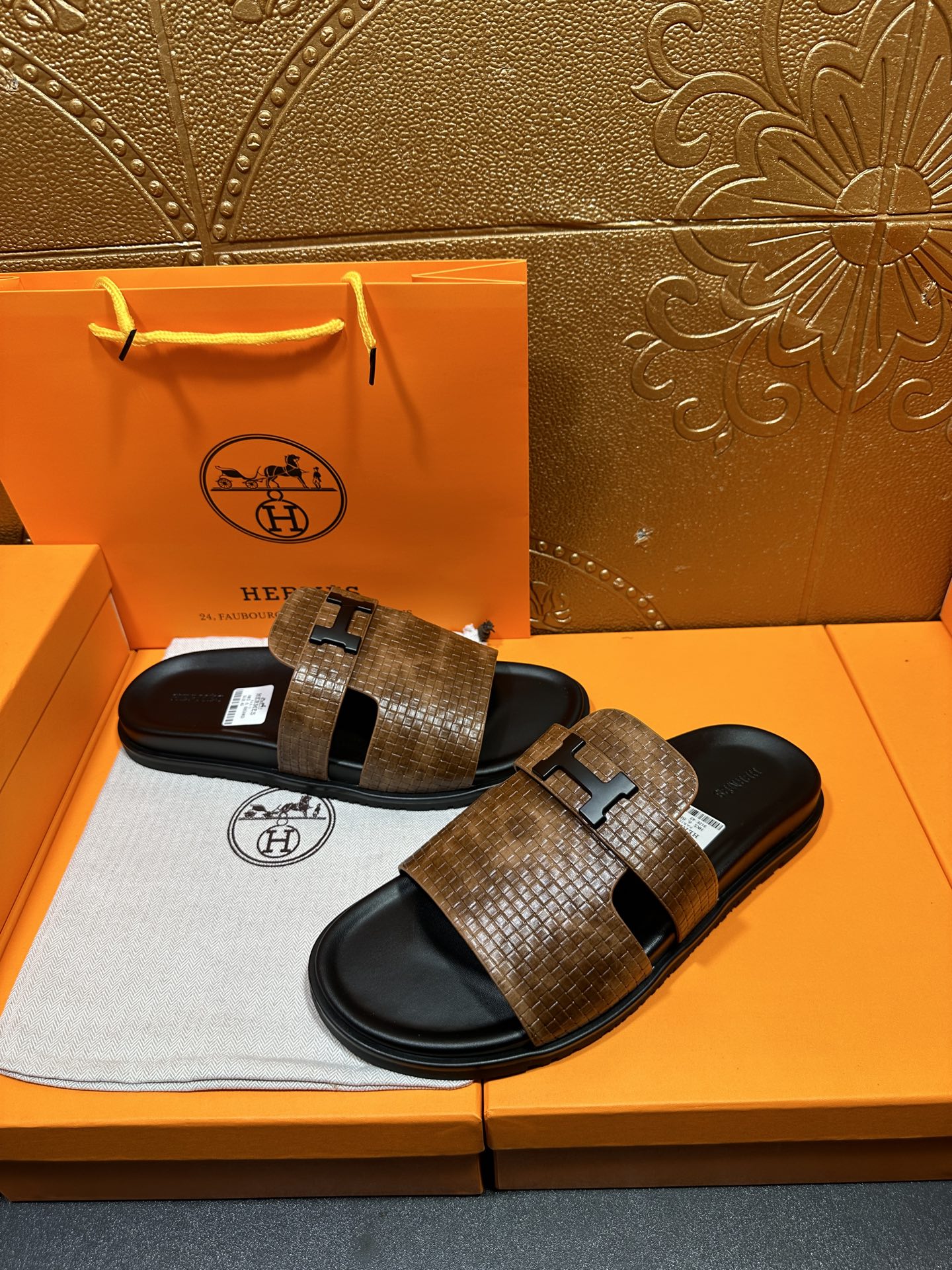 Hermes sandals with brown textured slide straps and black rubber soles