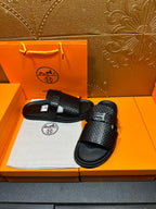 Hermes black textured slide sandals with front wide strap and curved black footbeds