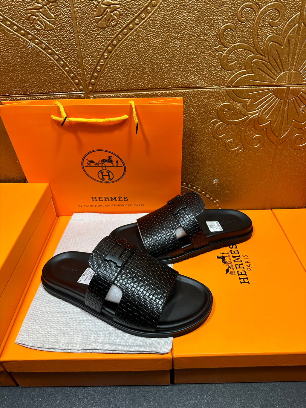 Hermes black textured slide sandals with wide band strap and flat rubber sole