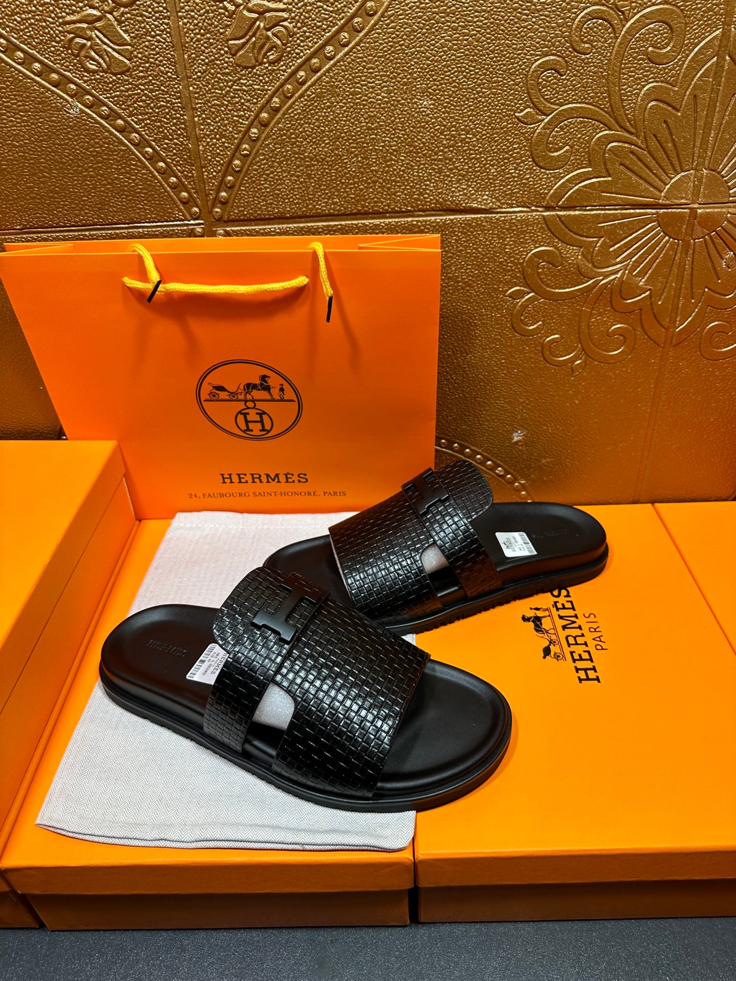 Hermes black textured slide sandals with wide band strap and flat rubber sole