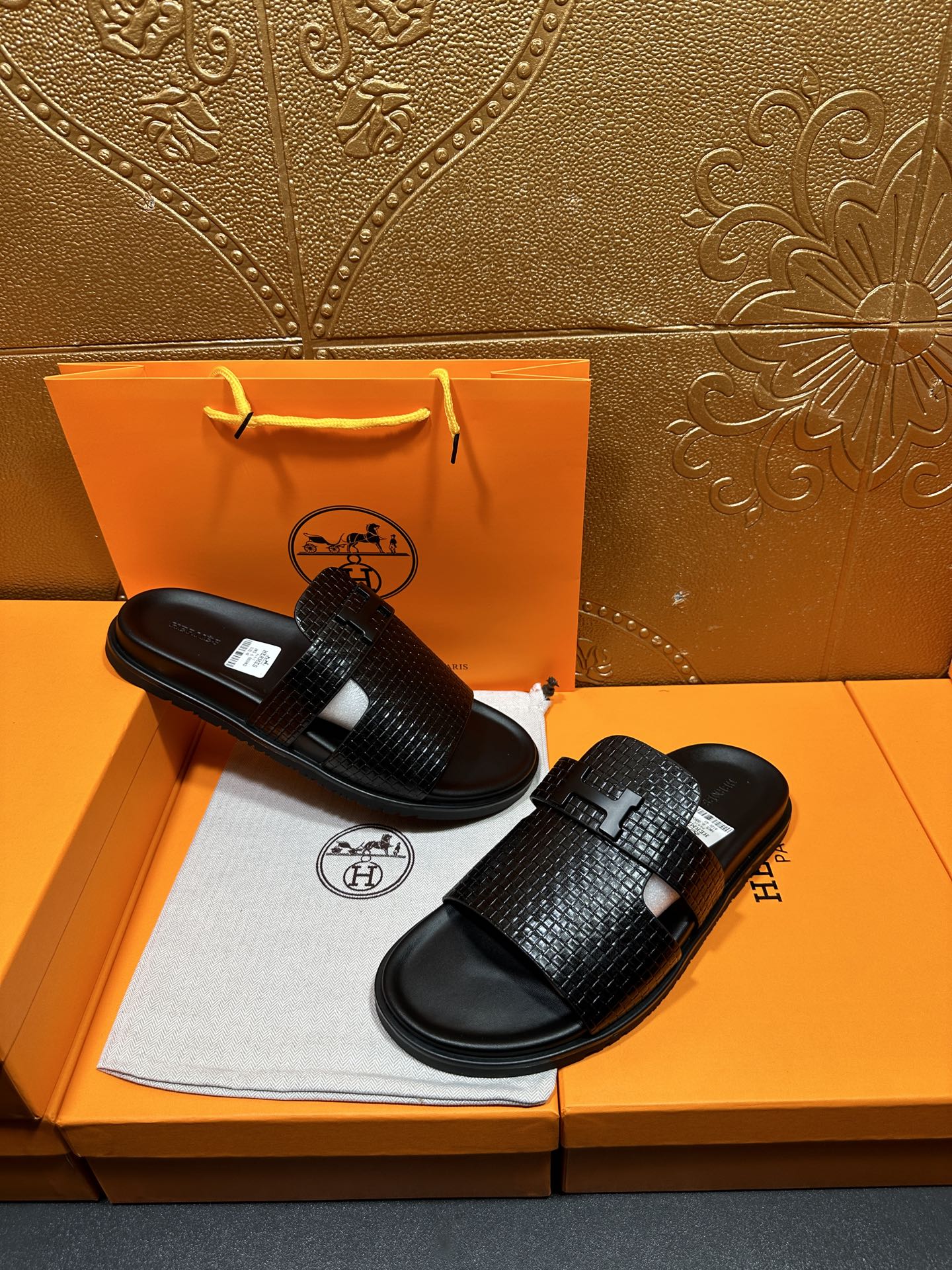 Hermes black textured slide sandals with wide crisscross straps and flat rubber base