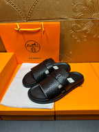 Hermes black textured slide sandals with adjustable strap and cushioned footbed