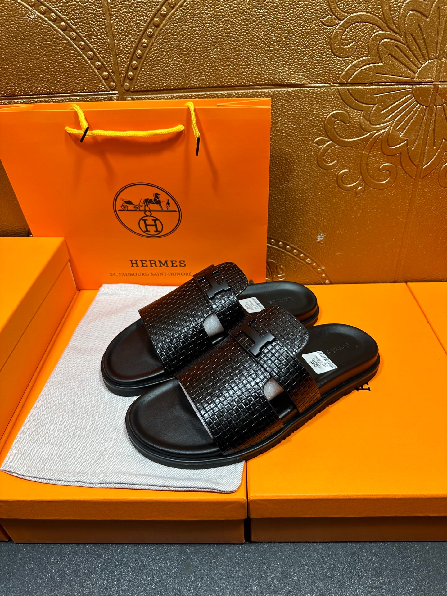 Hermes black textured slide sandals with adjustable strap and cushioned footbed
