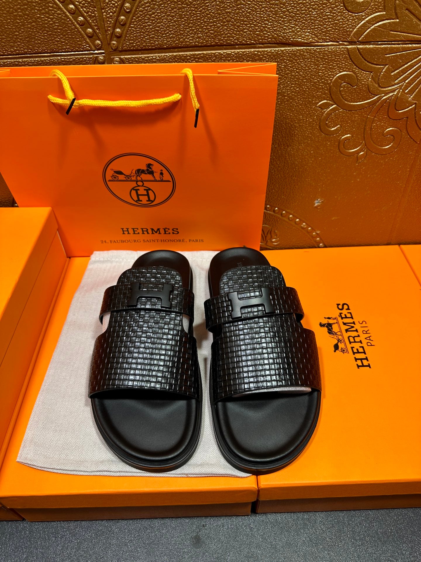 Hermes black textured slide sandals with wide cross-strap and black rubber footbed