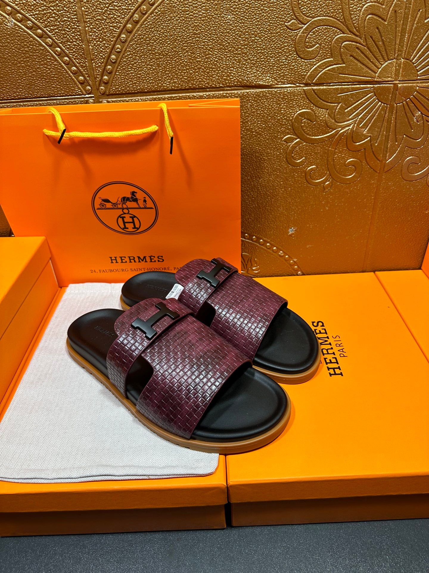 Burgundy textured slide sandals with black straps and squared logo buckle, black footbed
