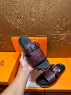 Hand-held Hermes slide sandal, burgundy textured strap with black squared logo buckle