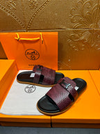 Hermes slide sandals, burgundy patterned strap bands and black buckle on dark slides