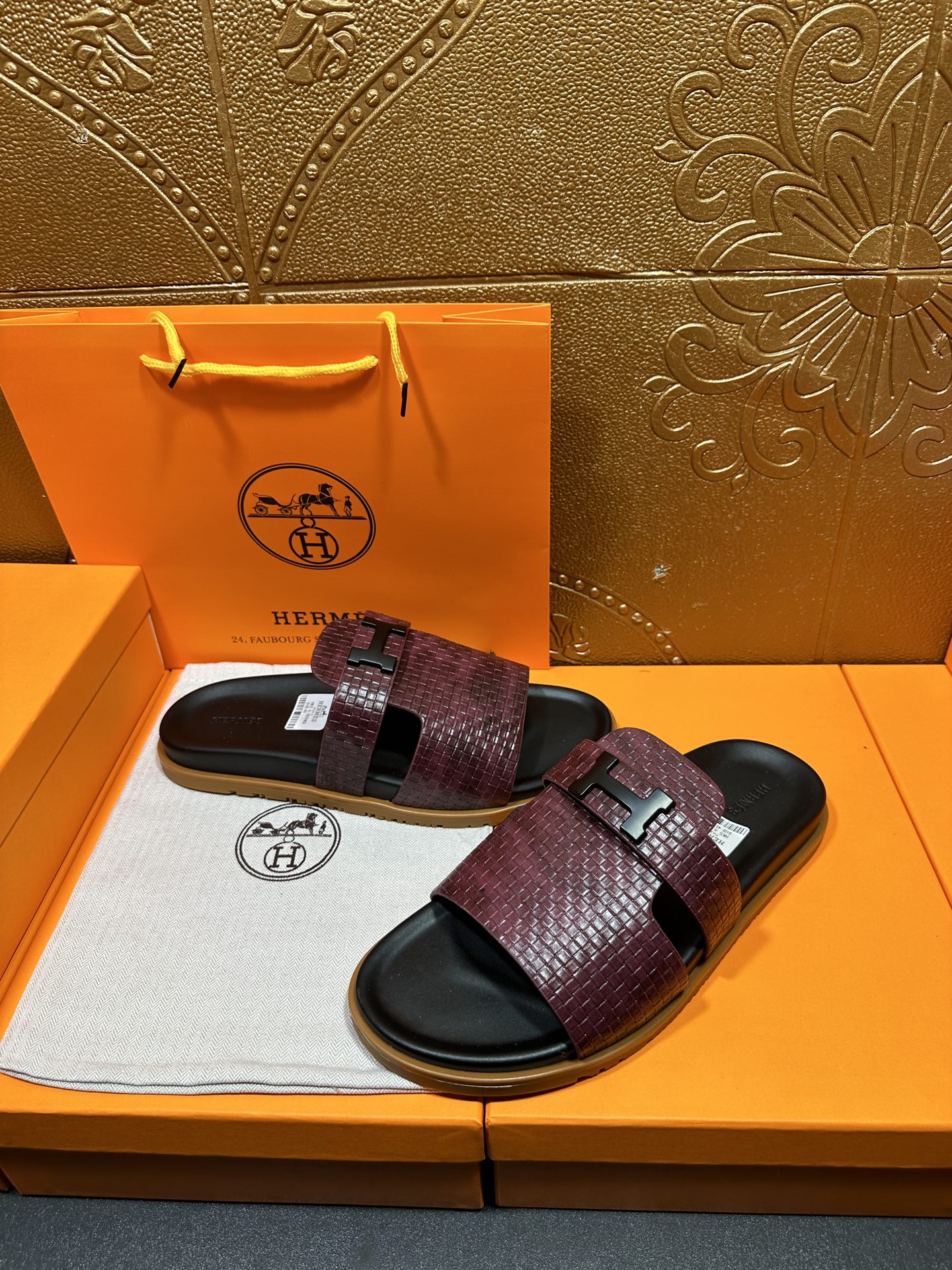 Hermes slide sandals, burgundy patterned strap bands and black buckle on dark slides