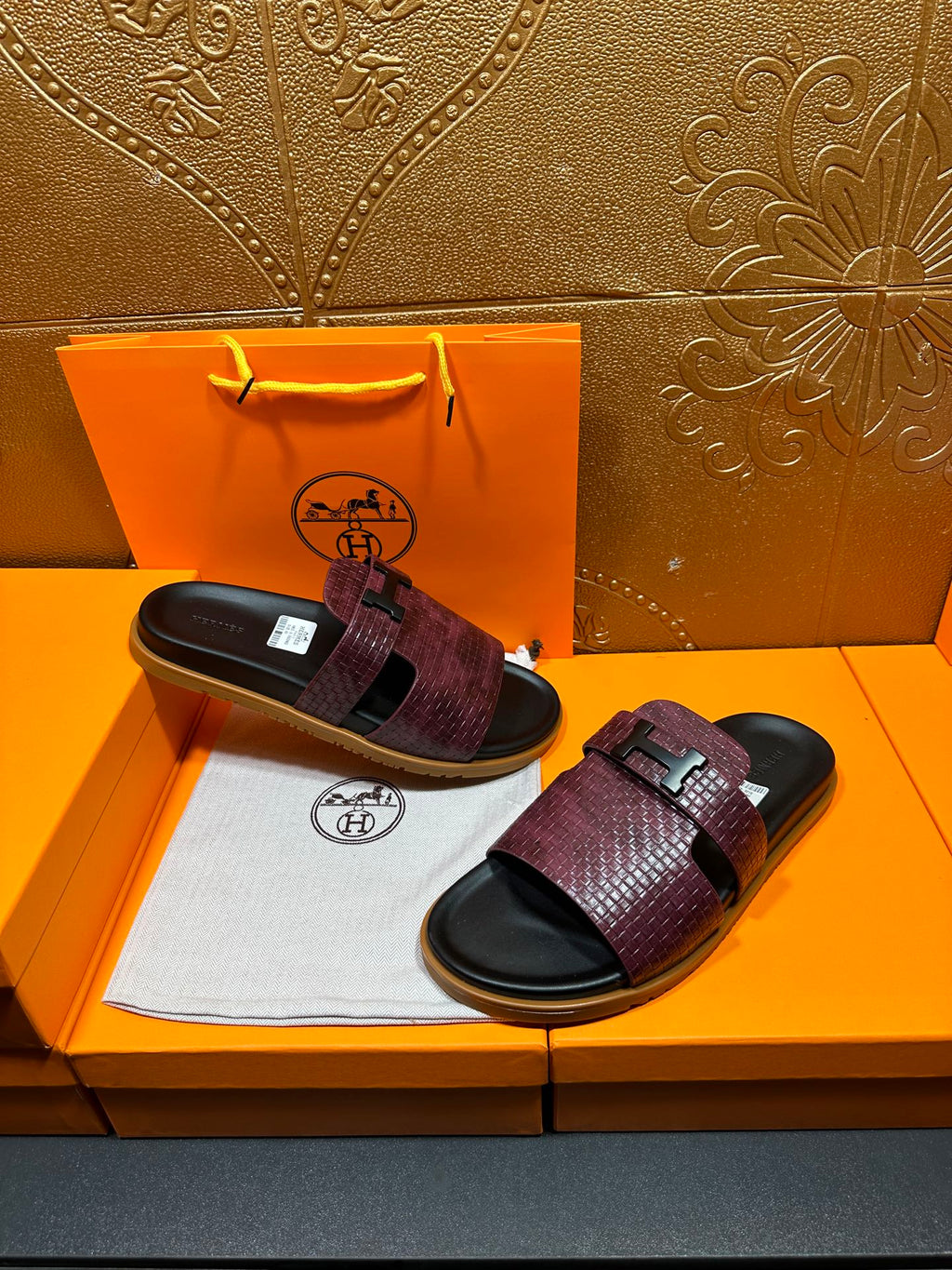 Hermes slide sandals, burgundy textured upper with black footbed and embossed logo buckle