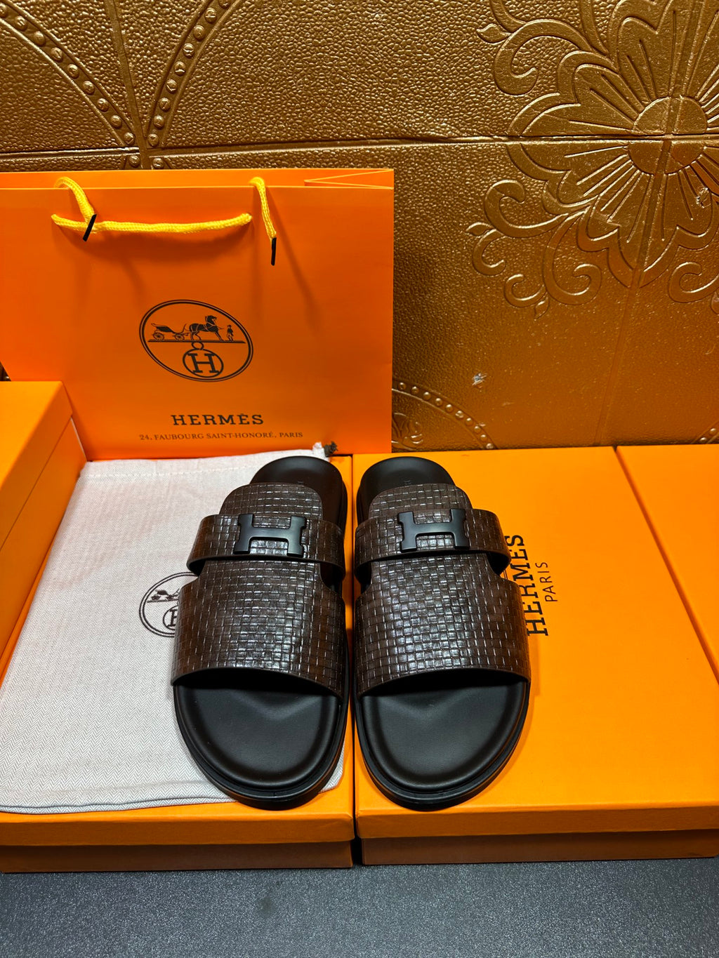 Hermes textured slide sandals with dark brown woven strap and black buckle
