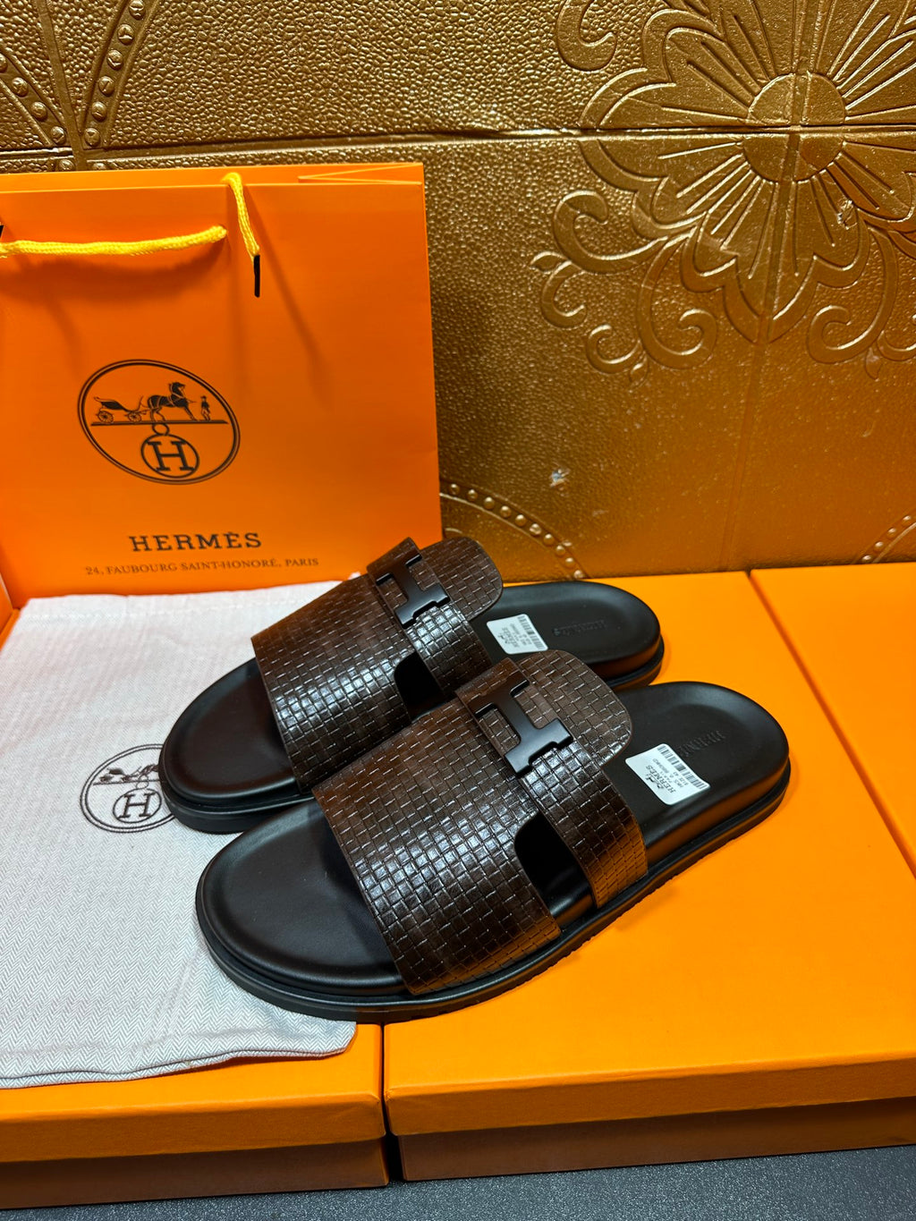 Hermes textured slide sandals, dark brown straps with black buckle detail