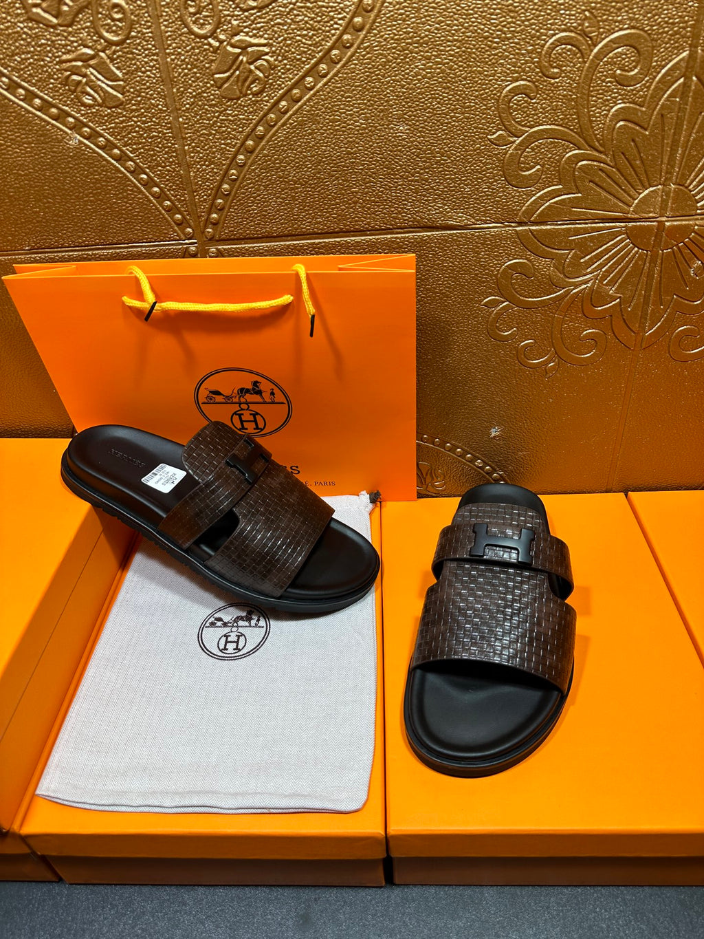 Hermes textured slide sandals set, one dark brown sandal and one pair with buckles