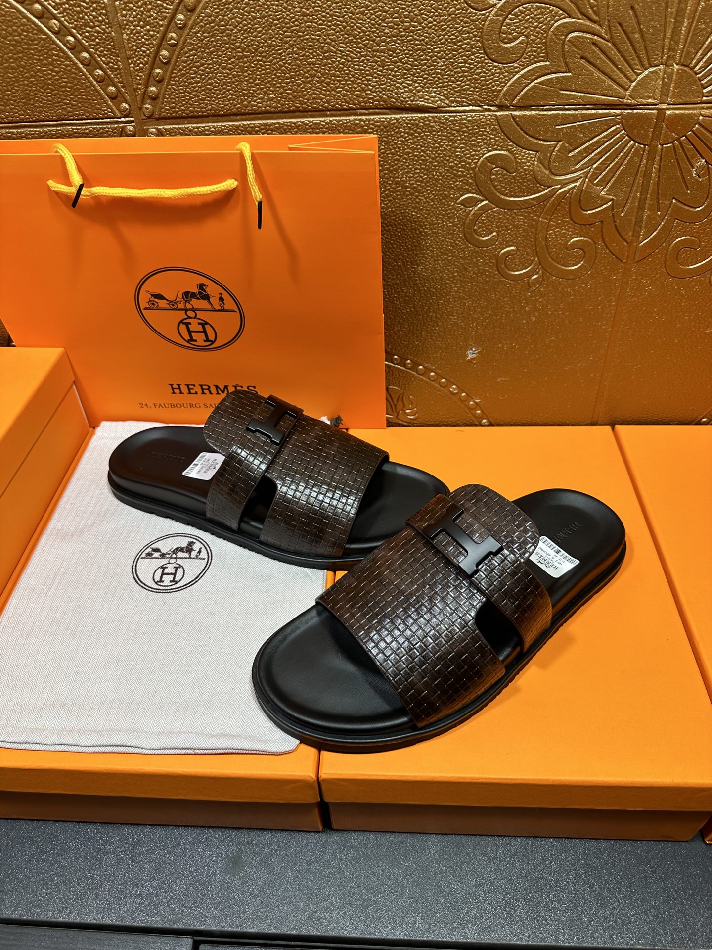 Hermes textured slide sandals, dark brown strap with black buckle over black soles