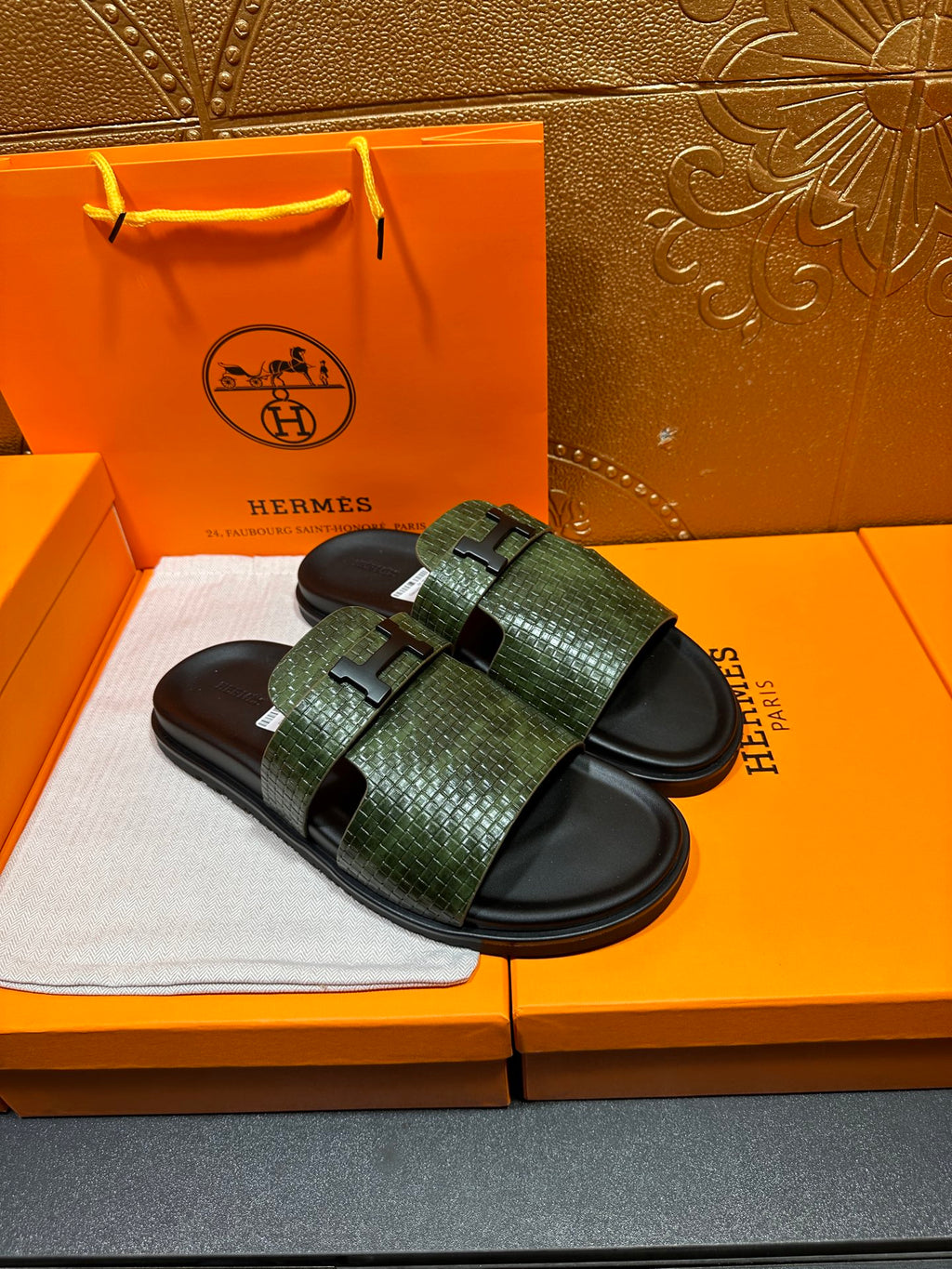Hermes slide sandals with green textured straps and black footbeds, side-by-side