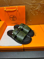 Hermes slide sandals with green textured straps and black footbeds, side-by-side