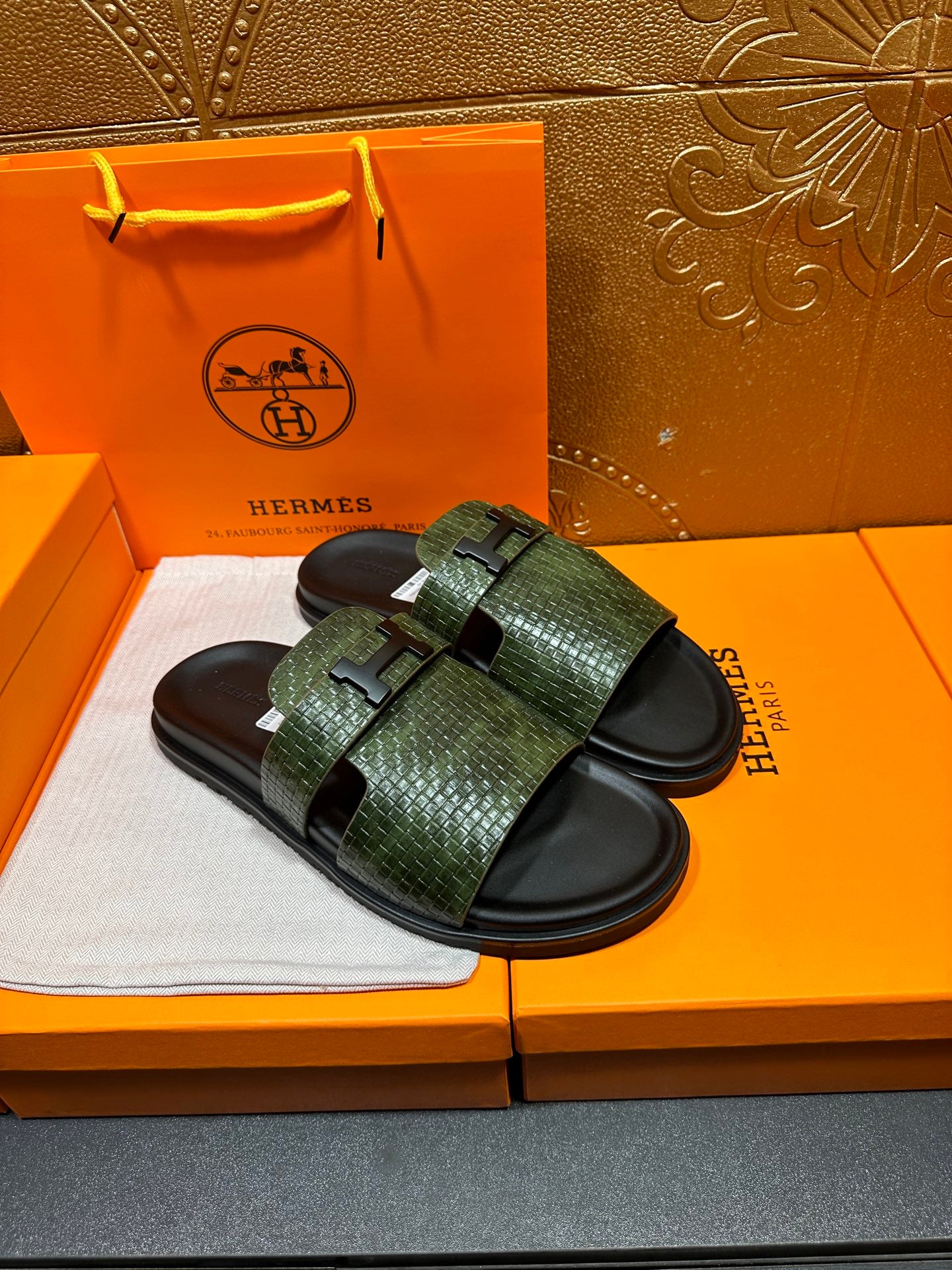 Hermes slide sandals with green textured straps and black footbeds, side-by-side