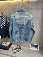 Light blue denim jacket back with large cross graphic and flower patches