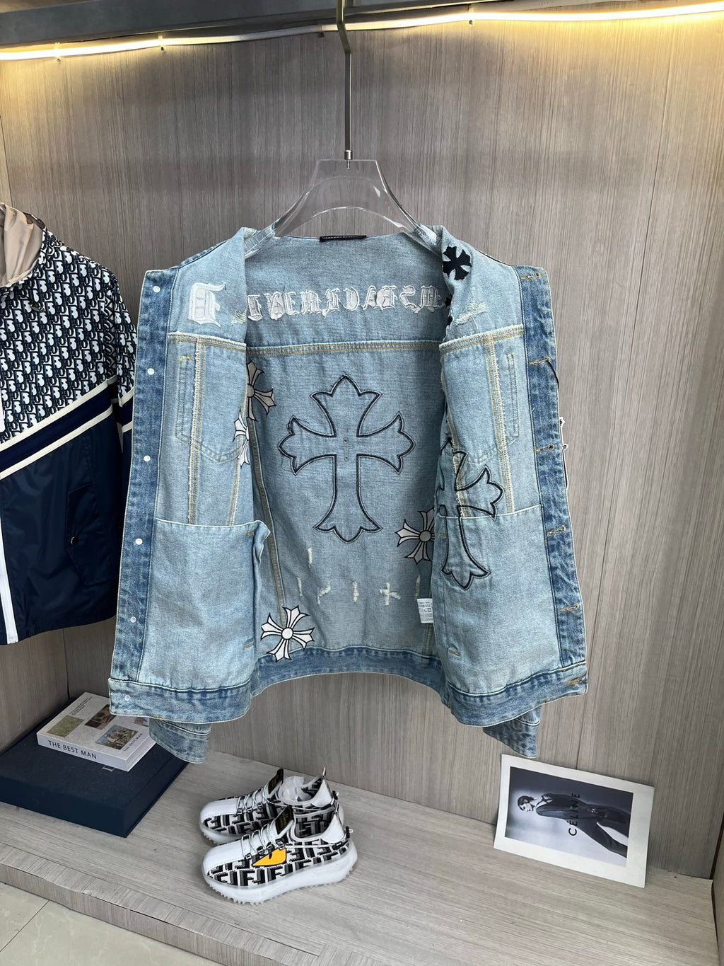 Light blue denim jacket front with cross and flower patches