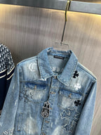 Light blue denim jacket chest close-up with collar patches and cross motifs