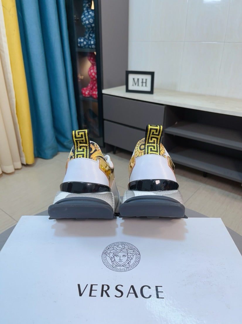 Versace chunky sneakers, white uppers with gold Greek-key trim and dark sole