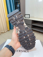 Versace chunky sneakers outsole view, dark rubber tread with ridged traction blocks