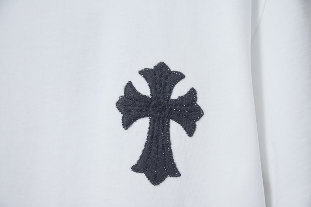 White T-shirt with black cross graphic patch near the chest