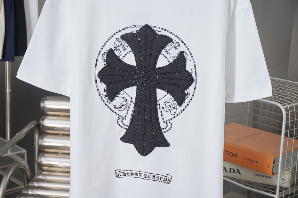 White graphic T-shirt with large black cross emblem and circular pattern