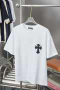 White graphic T-shirt with small black cross emblem on the chest