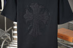 Black T-shirt chest features dark circular rhinestone logo