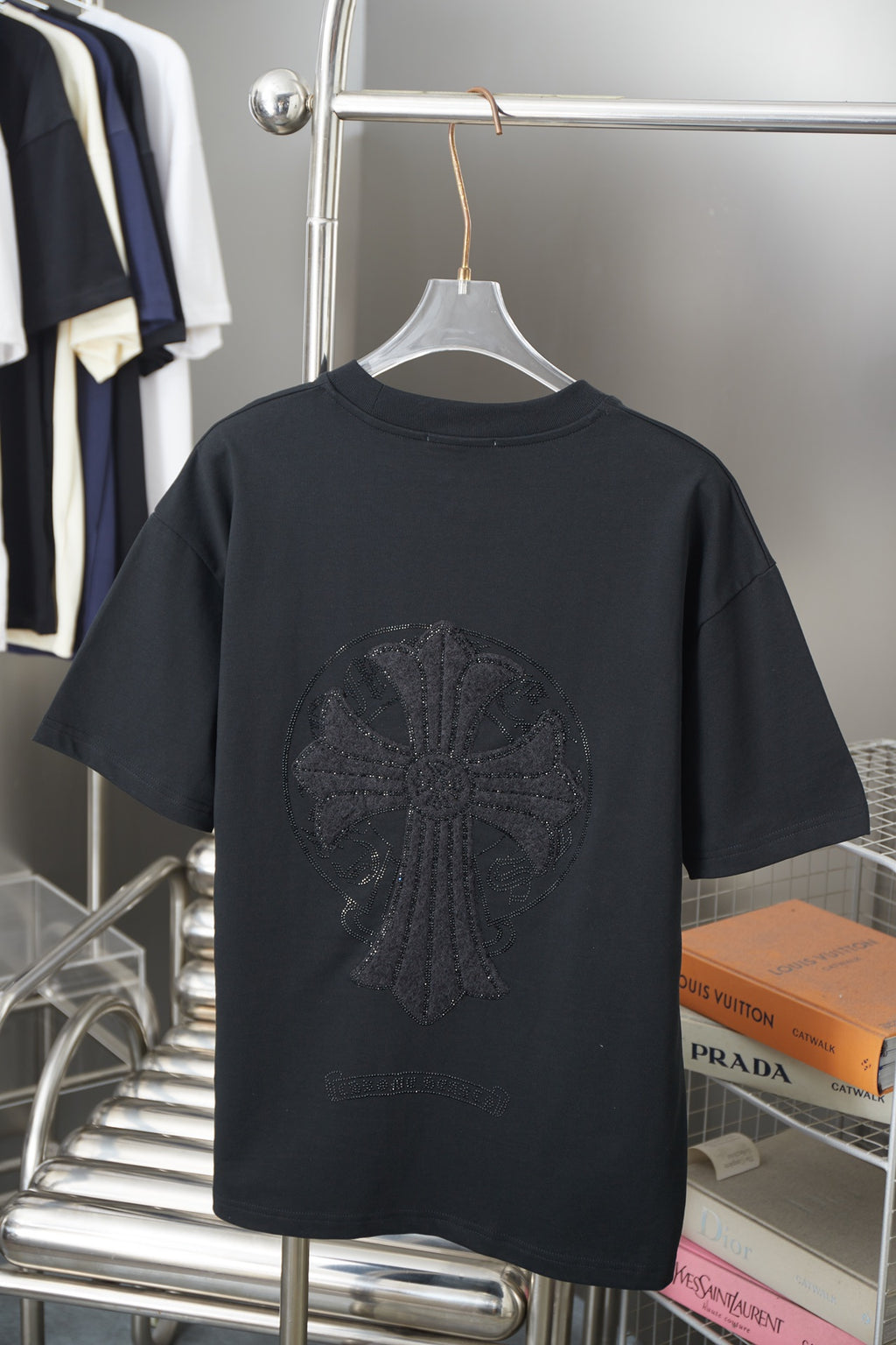 Black short-sleeve T-shirt with large dark circular logo graphic