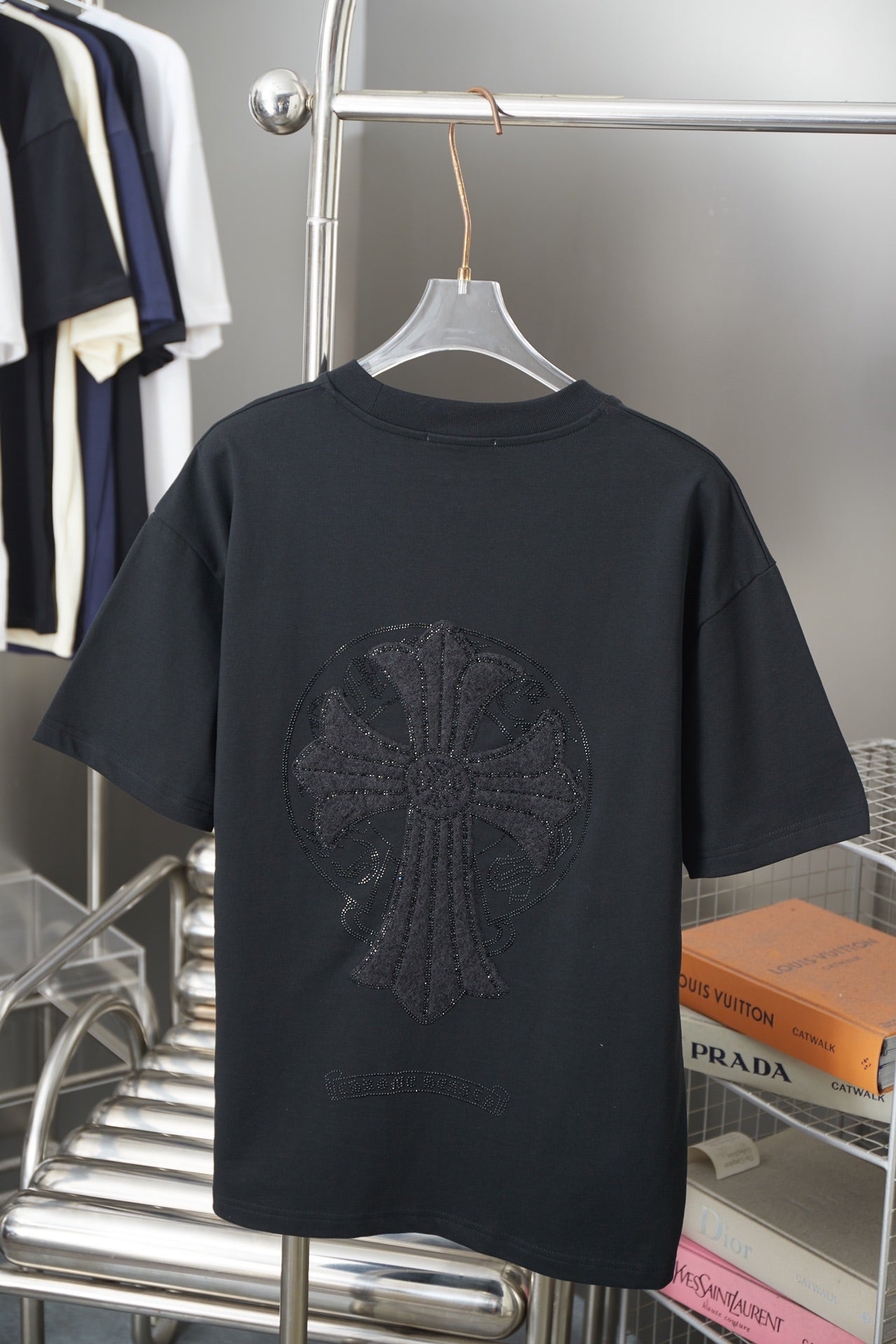 Black short-sleeve T-shirt with large dark circular logo graphic
