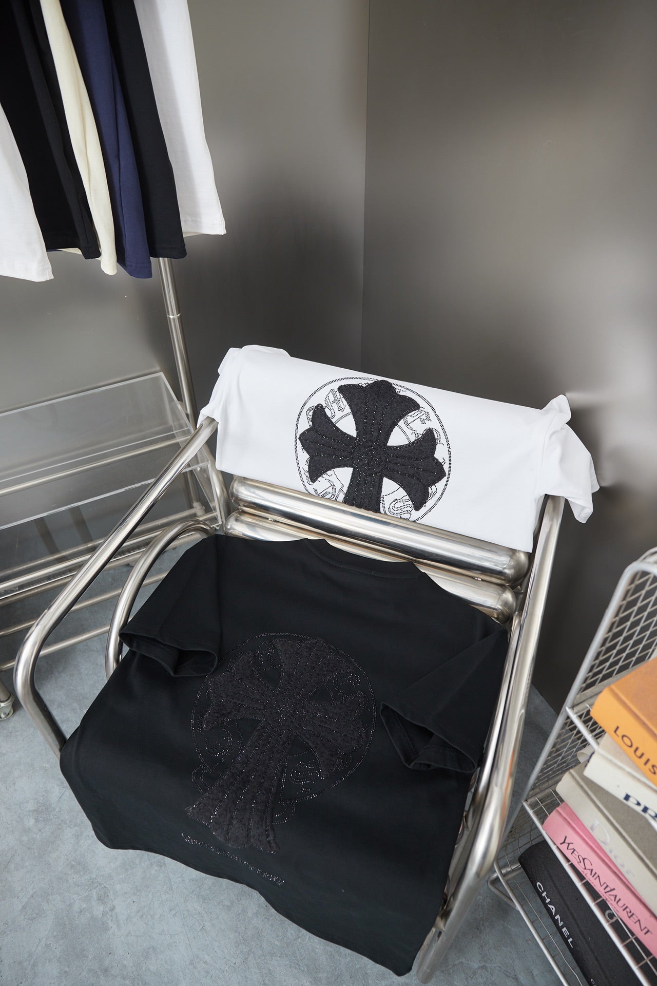 Folded black and white T-shirts with large circular logo graphic
