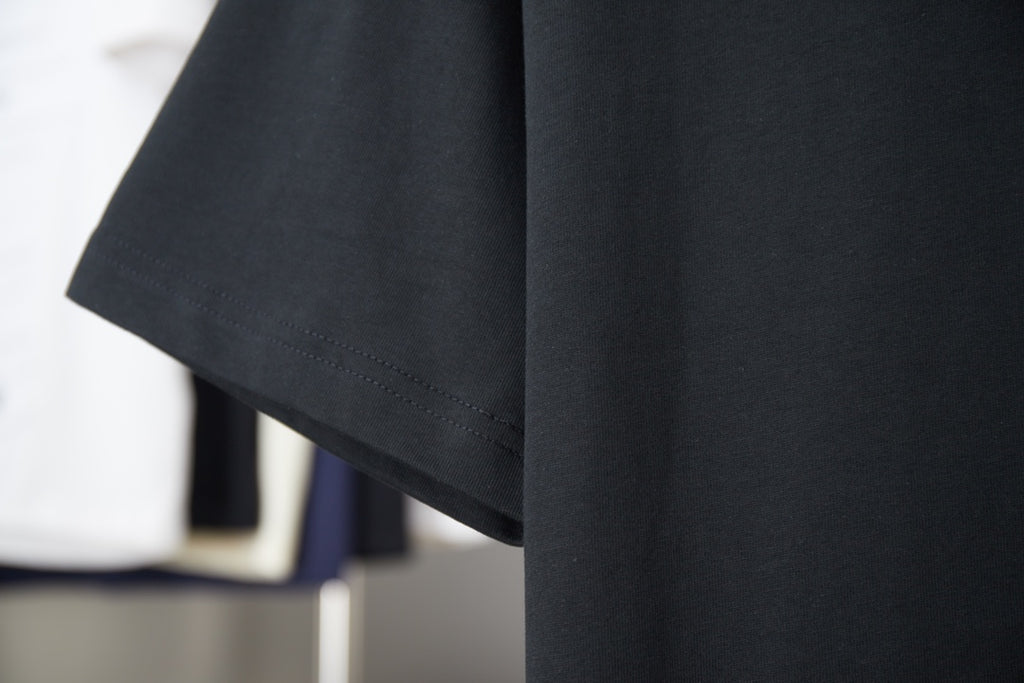 Black T-shirt with short sleeves and neat hem stitching