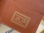Brown leather wallet interior panel with embossed emblem and decorative text