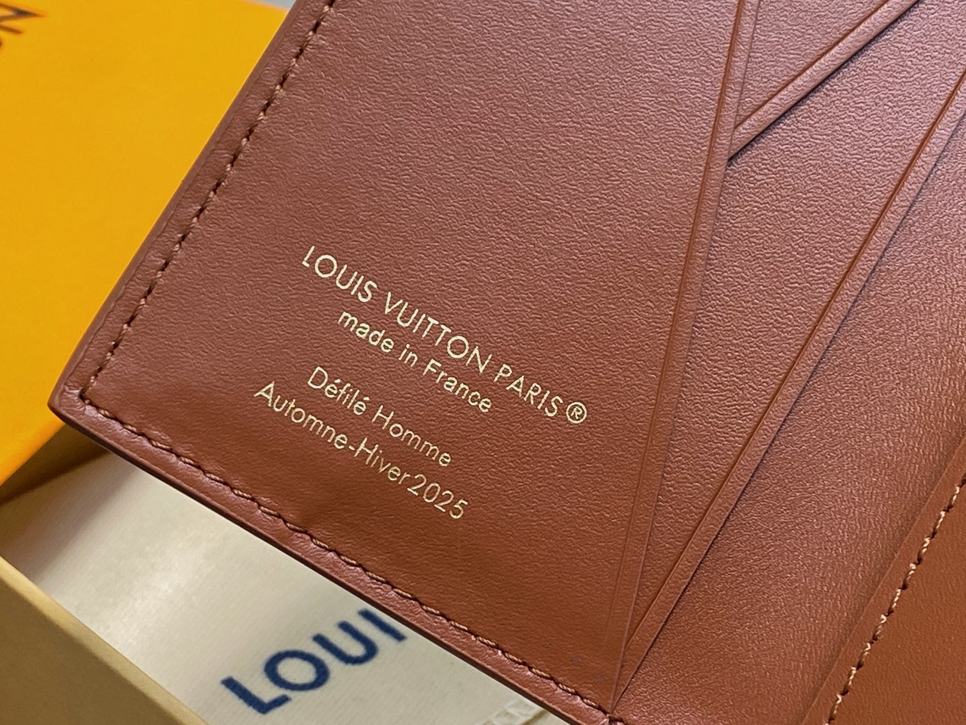 Brown leather wallet panel with 'Louis Vuitton' and 'made in France' text