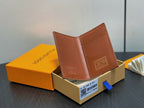 Brown leather small wallet open with card slots and embossed mark, in box