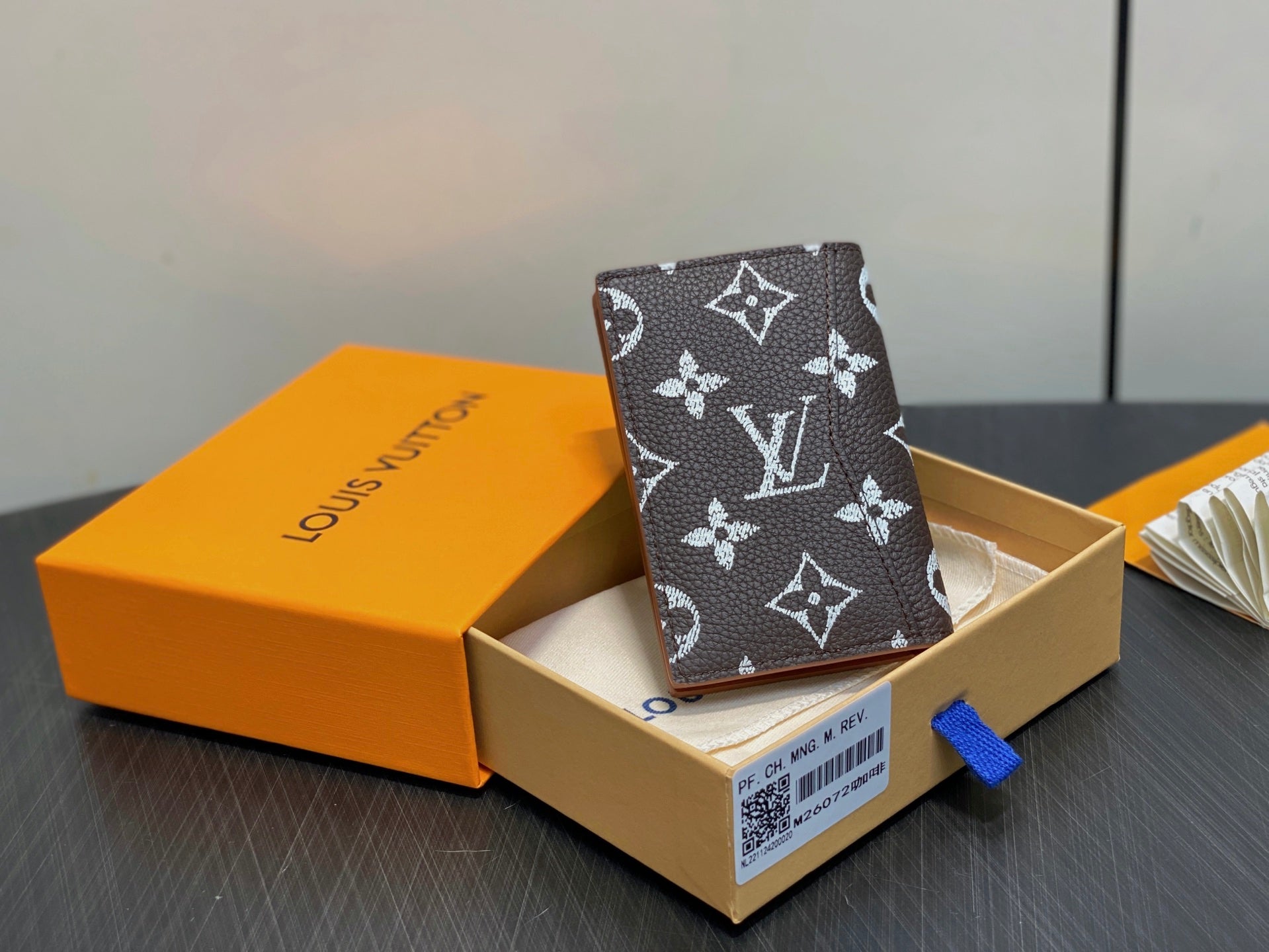 Monogram small wallet with dark brown and white pattern, upright in gift box